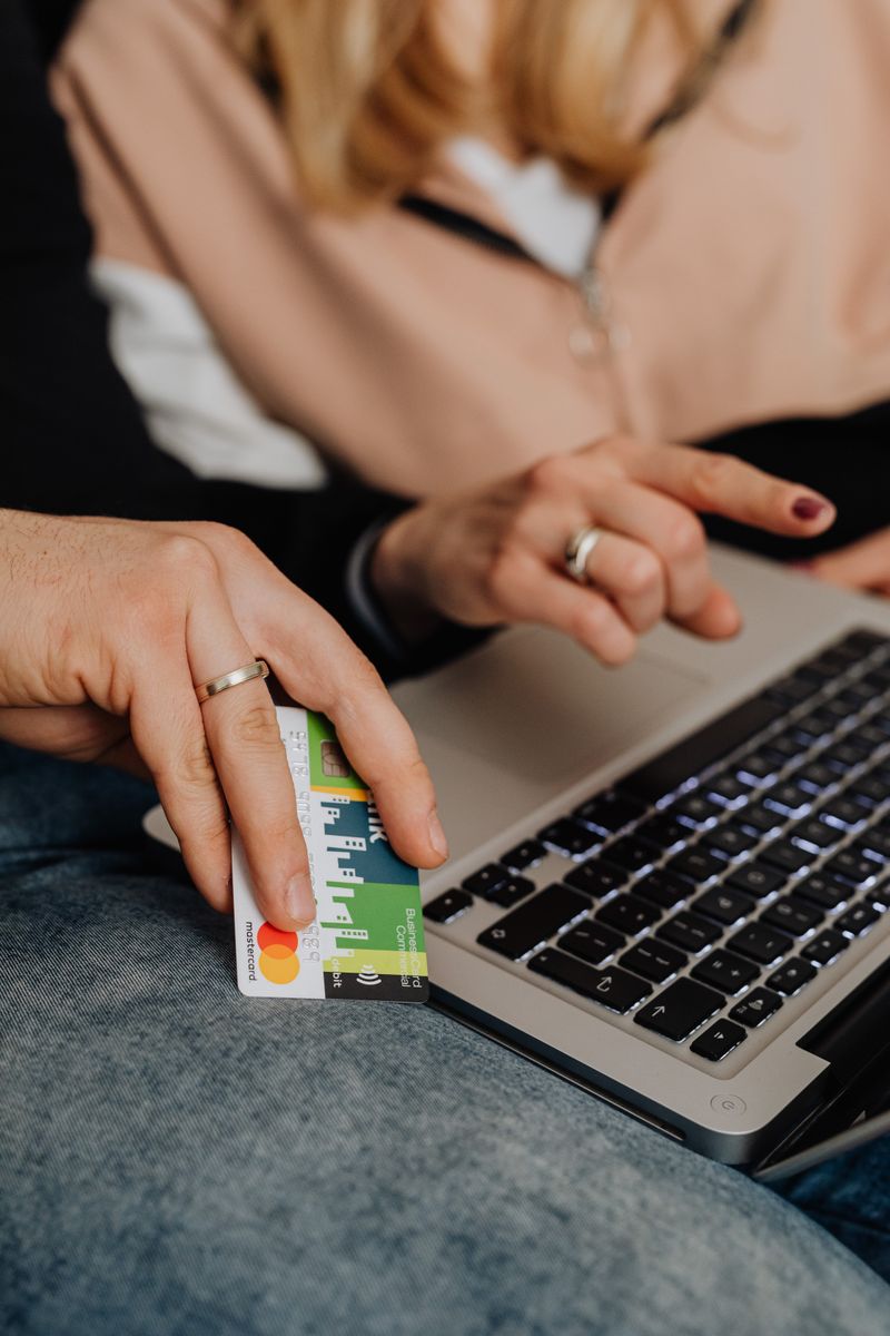 Two people reviewing shared household expenses on a laptop.